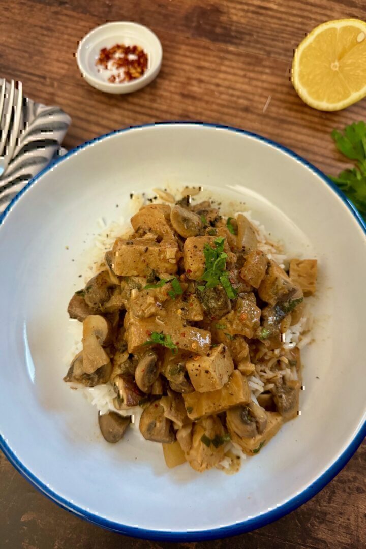 Tempeh stroganoff served with rice in a bowl