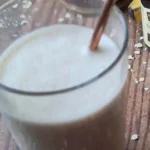 a peanut butter and oat smoothie served in a glass