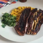 roast miso aubergine served with couscous and wilted spinach
