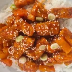 takeaway style crispy chilli tofu served on a bed of rice