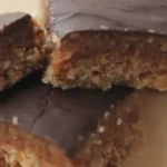 three vegan caramel slices stacked on a plate