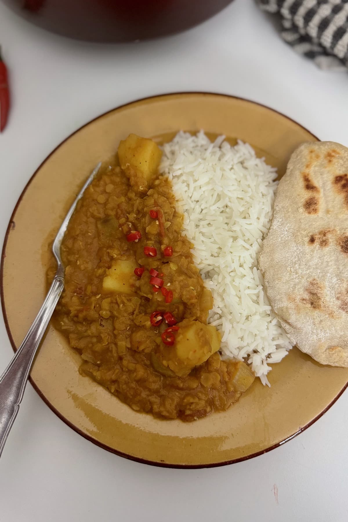 lentil and potato dahl served with rice and naan bread