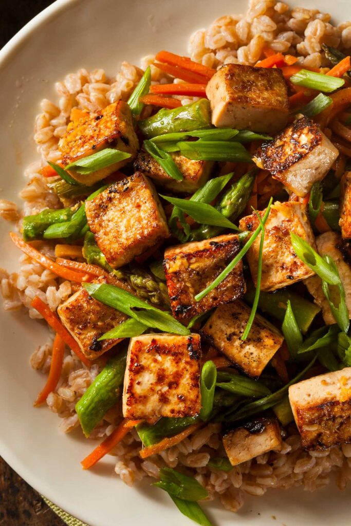 tofu served on a plate with rice and veggies
