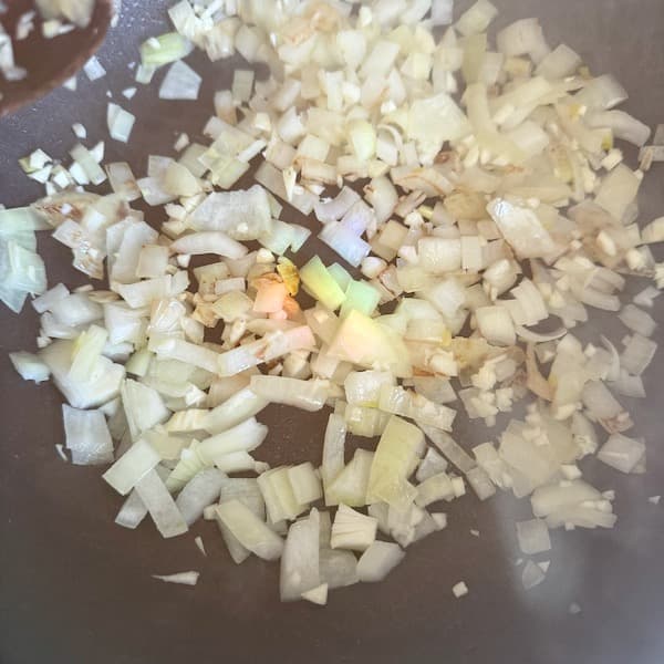 onions cooking in a pot as a base for a black bean curry