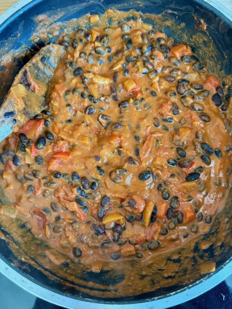 black bean curry cooking in a deep pan