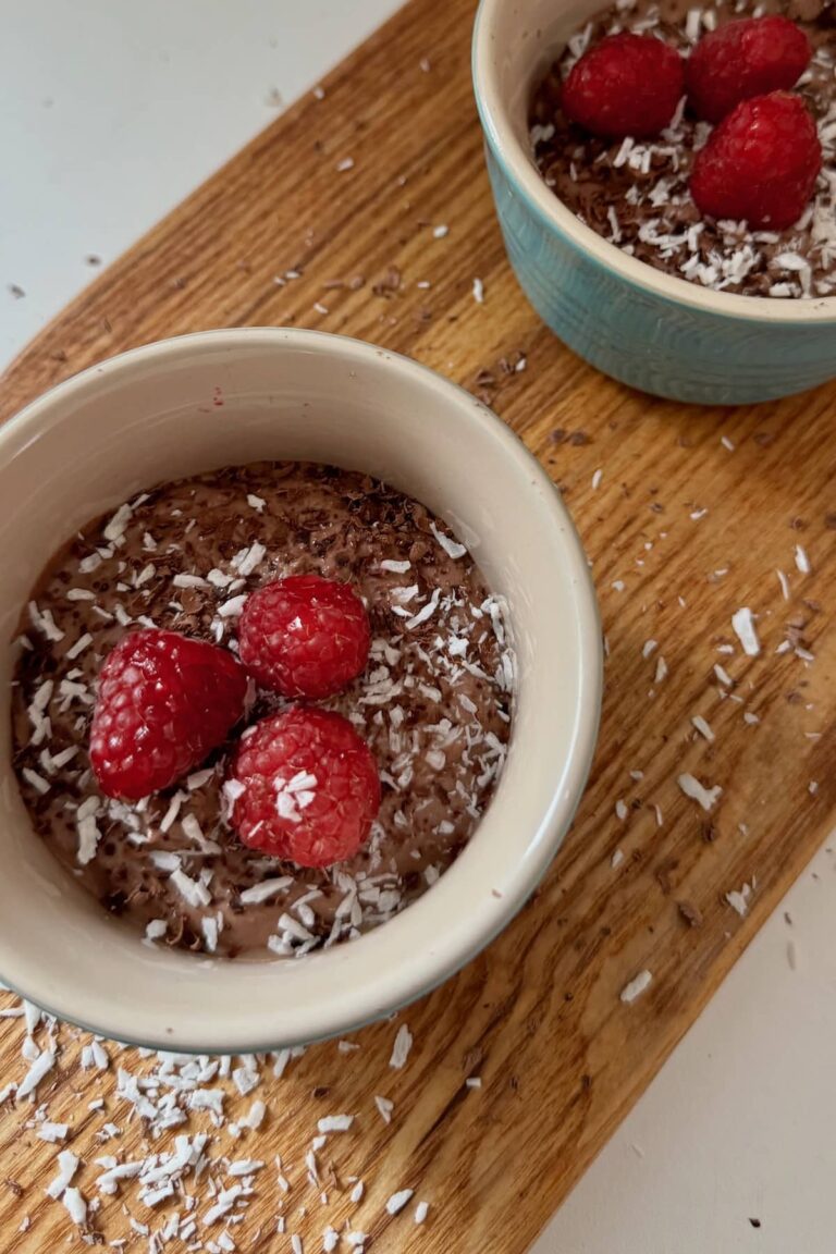 silken tofu mousse served in two ramekins with raspberries and shredded coconut