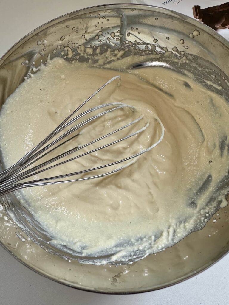 silken tofu and maple syrup being whisked in a bowl