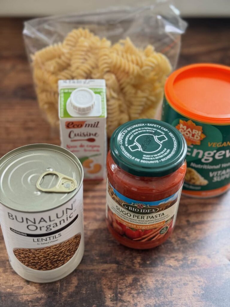 ingredients to make a 10 minute vegan pasta with lentils dish displayed on a table