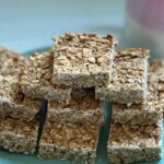 low calorie breakfast oat bars laid out on a plate with a coffee