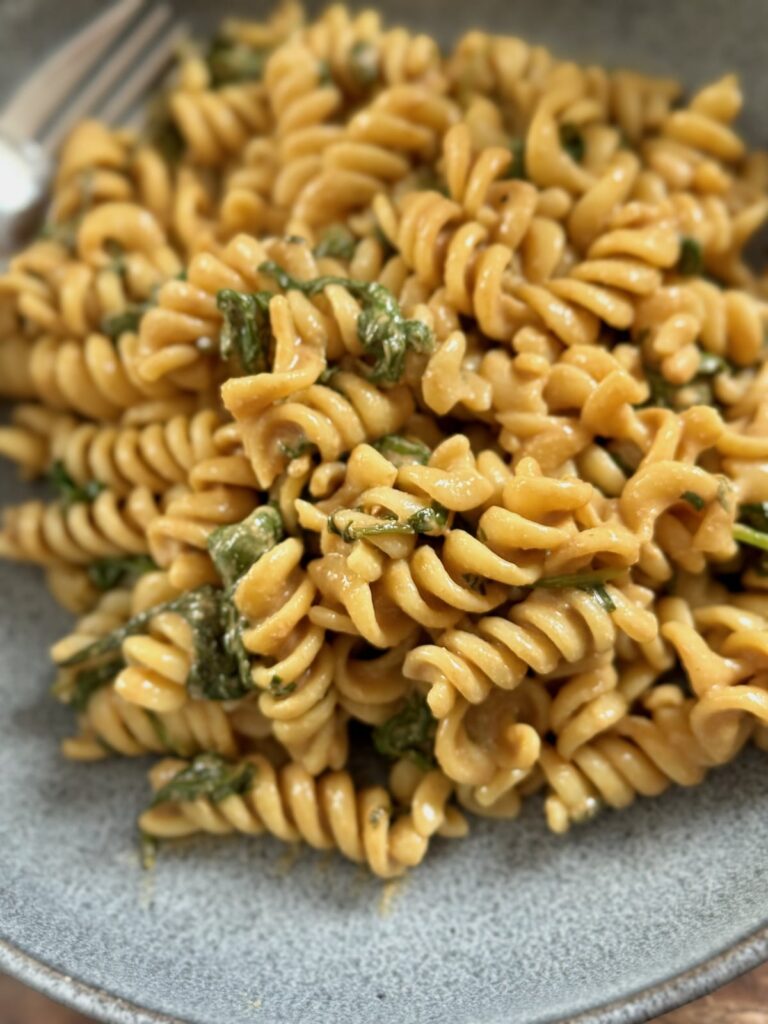 tahini lemon pasta on a plate and pictured up close