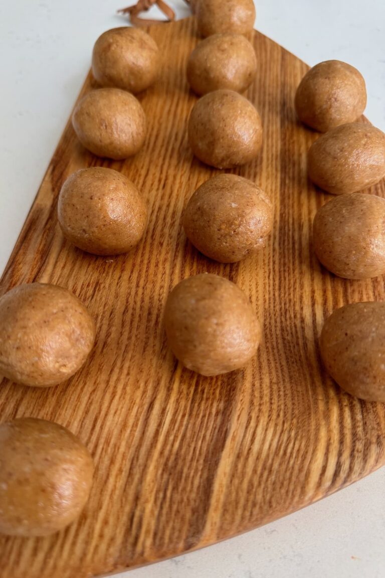 almond peanut butter balls laid out on a board