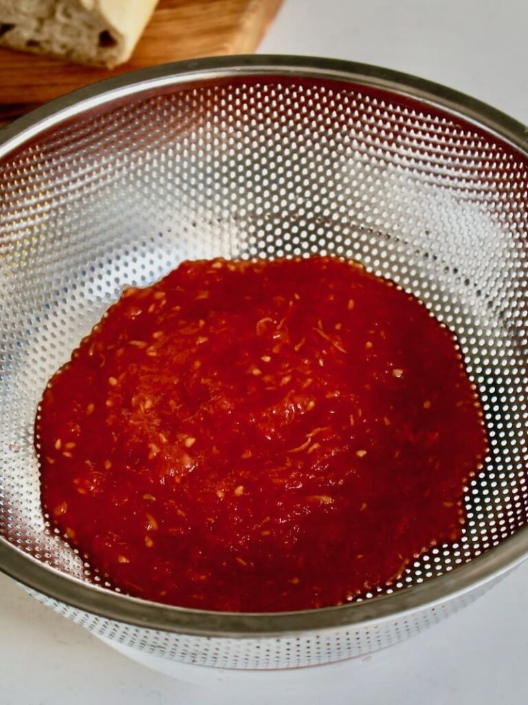 drained tomatoes in a sieve for pan con tomate